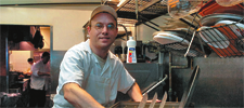 man doing dishes and smiling