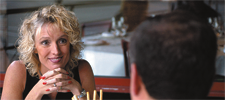 woman smiling at man across the table