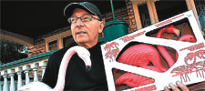 man holding collector pink garden flamingos